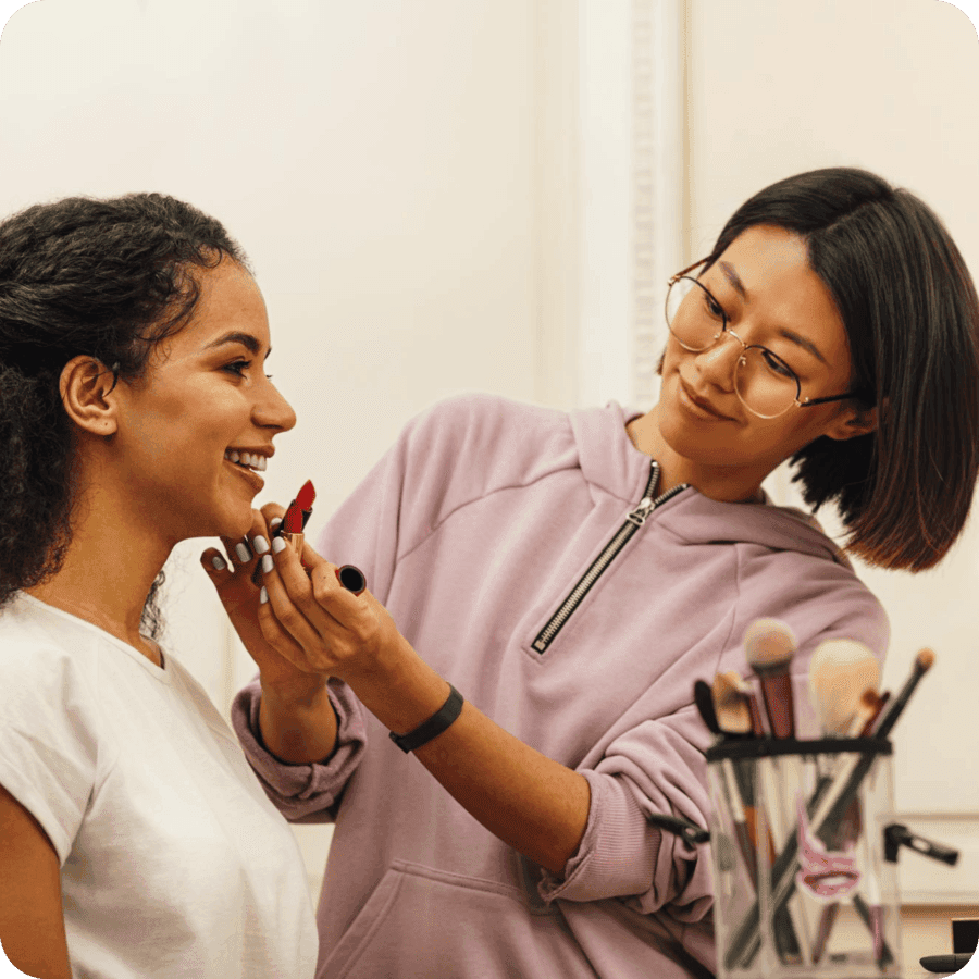 A makeup artist applying lipstick